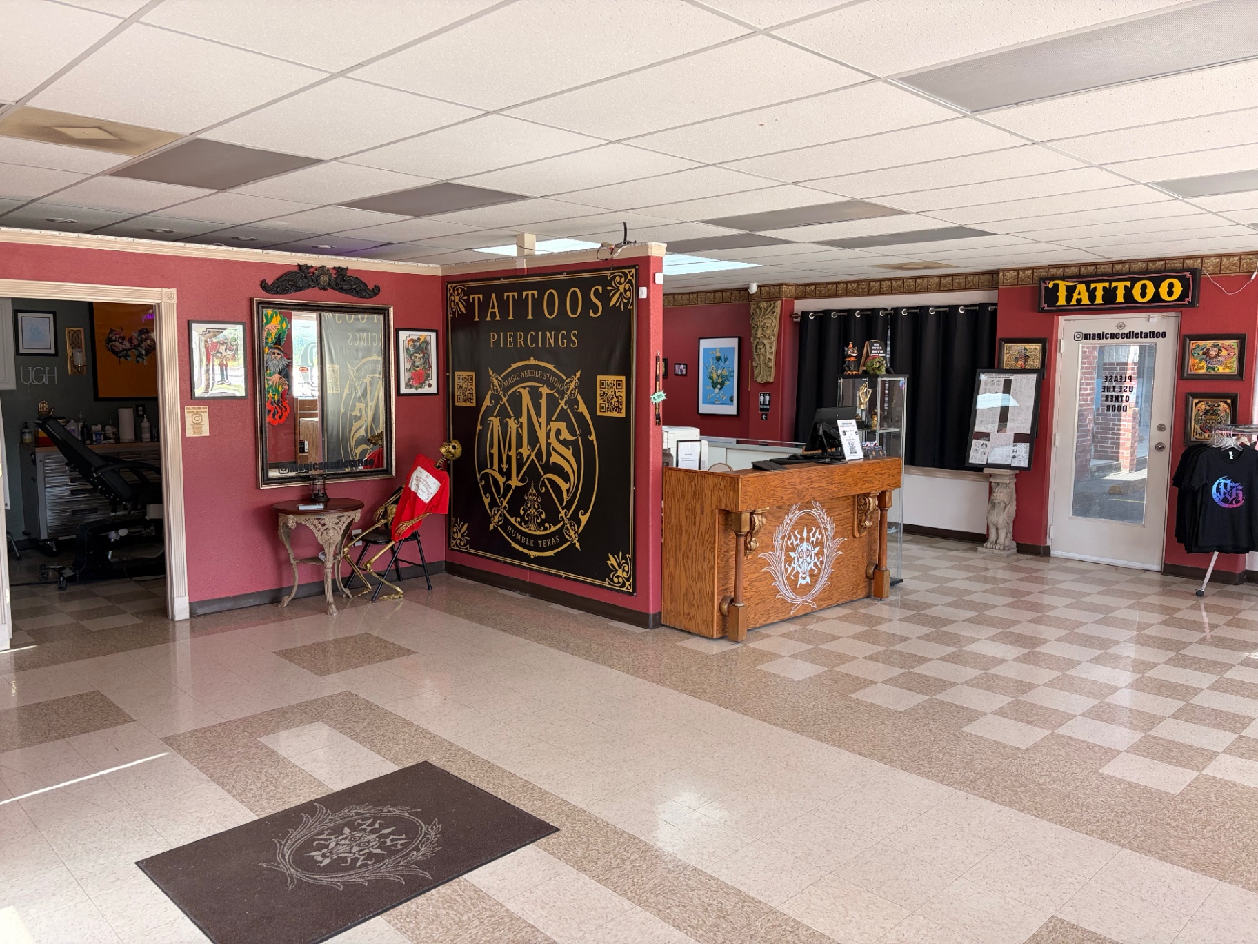 Magic Needle Studio lobby with TATTOOS & PIERCINGS banner