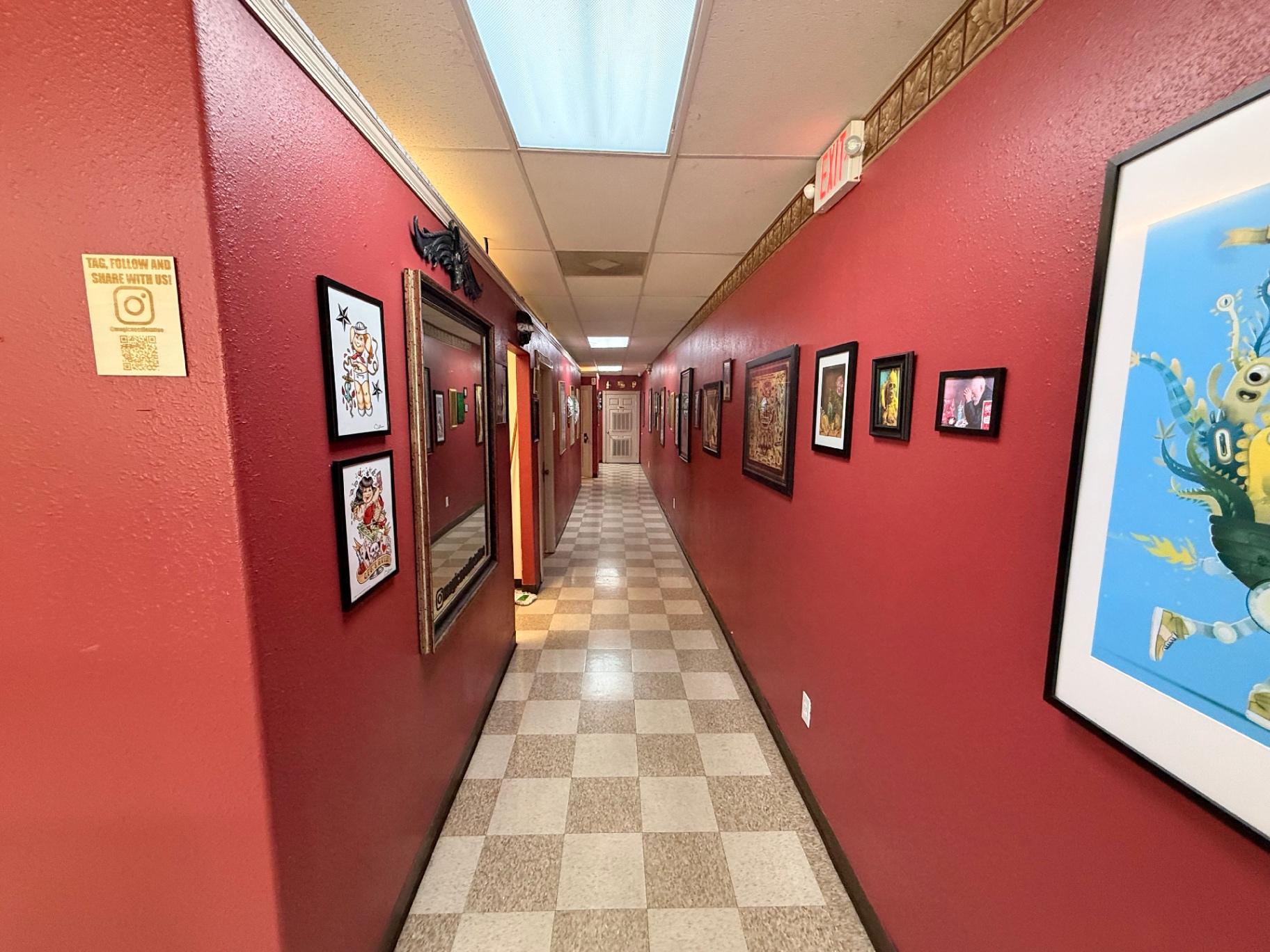 Studio hallway lined with framed tattoo art
